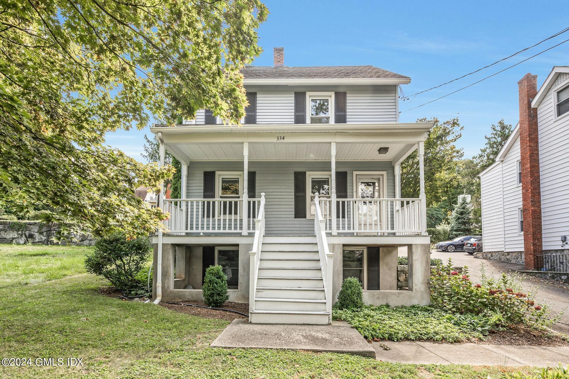 334 Palmer Hill Road Riverside, CT 06878 - Photo 1 of 19 a front view of a house with garden