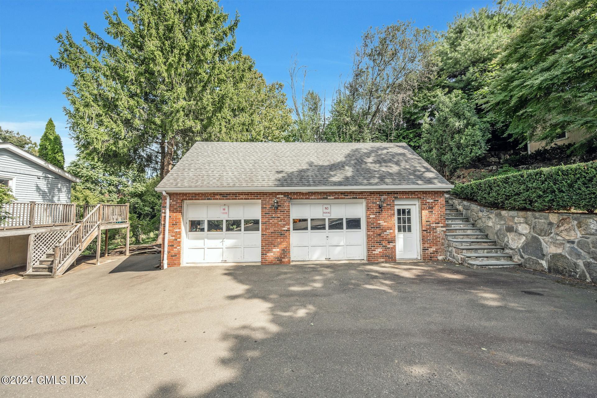 334 Palmer Hill Road Riverside, CT 06878 - Photo 19 of 19 a front view of a house with a garden