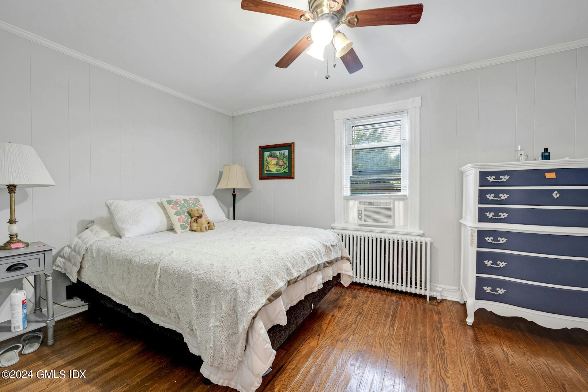 334 Palmer Hill Road Riverside, CT 06878 - Photo 5 of 19 a bedroom with a bed and wooden floor