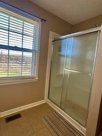 a bathroom with a glass shower door