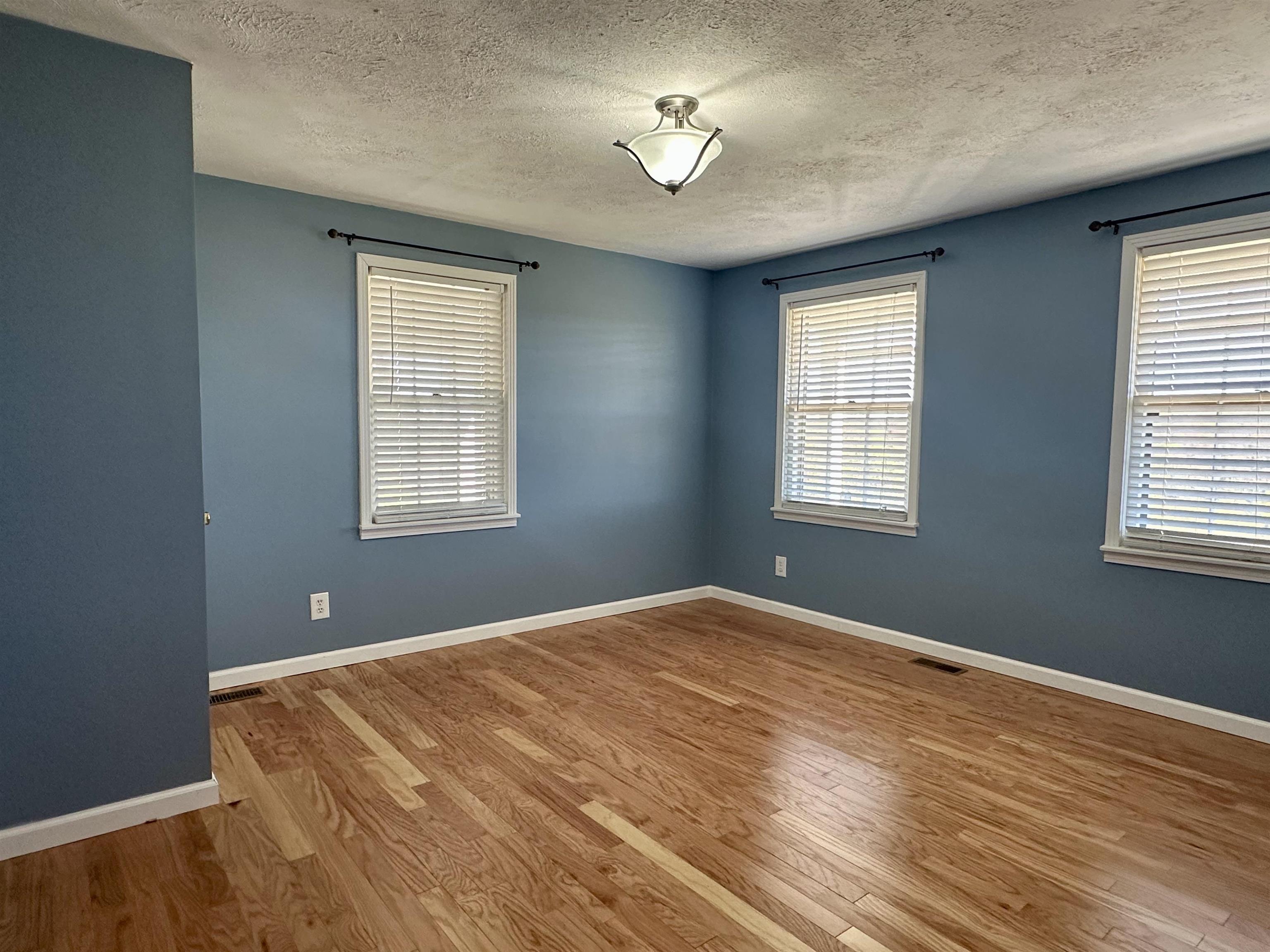 136 Perkins Street Selmer, TN 38375 - Photo 14 of 25 a bedroom with a bed and window