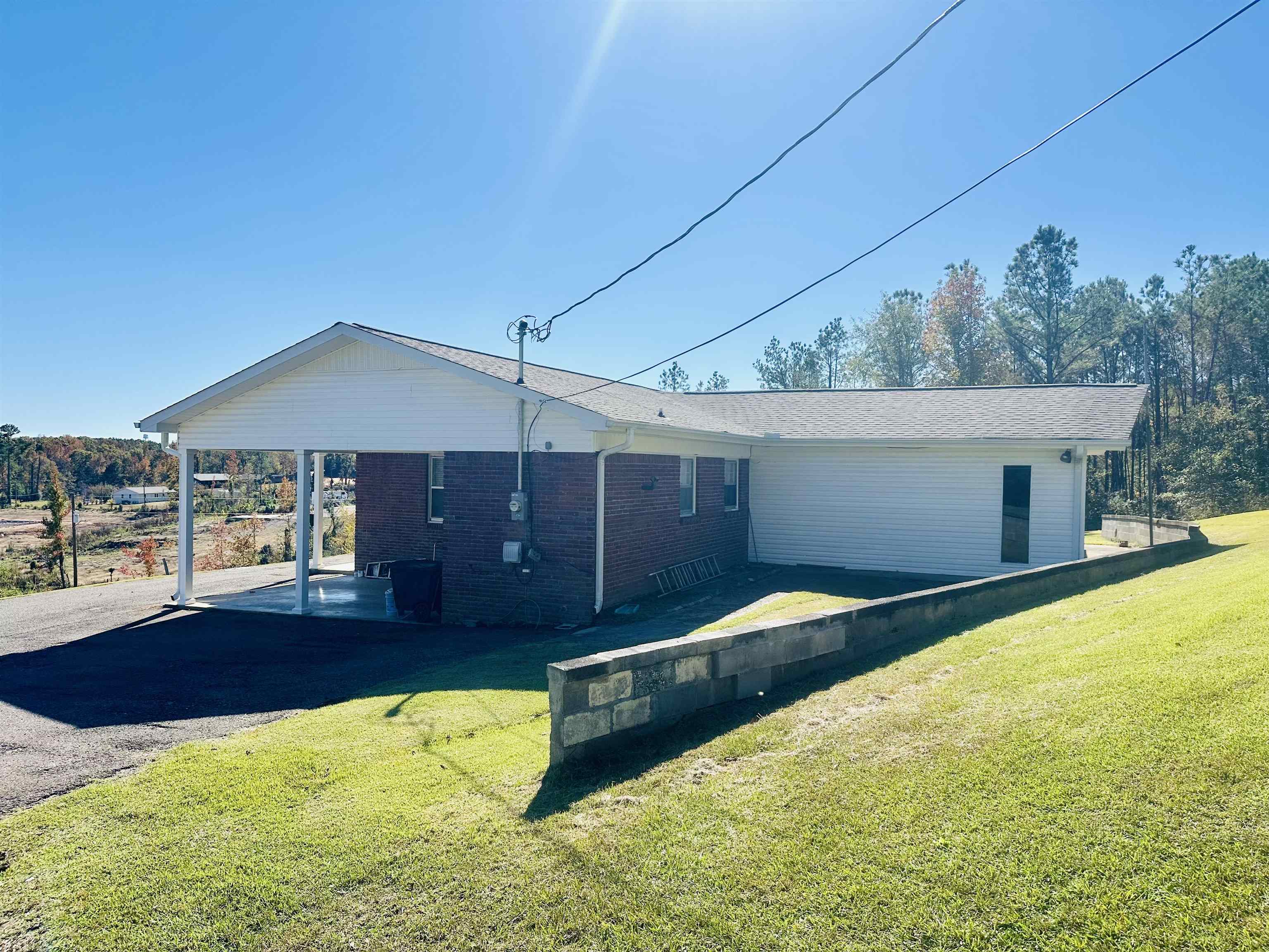 136 Perkins Street Selmer, TN 38375 - Photo 21 of 25 a front view of house with yard and trees in the background