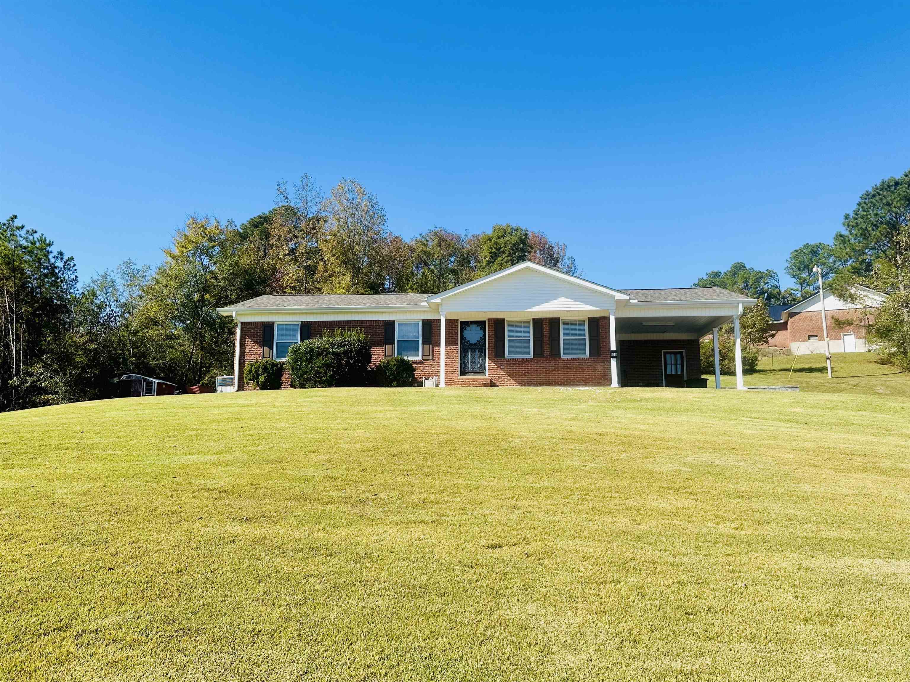 136 Perkins Street Selmer, TN 38375 - Photo 24 of 25 a front view of a house with a yard