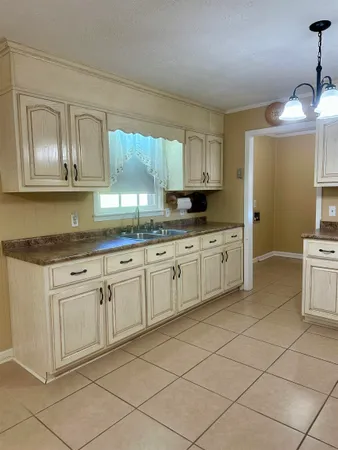 a kitchen with cabinets appliances and a window