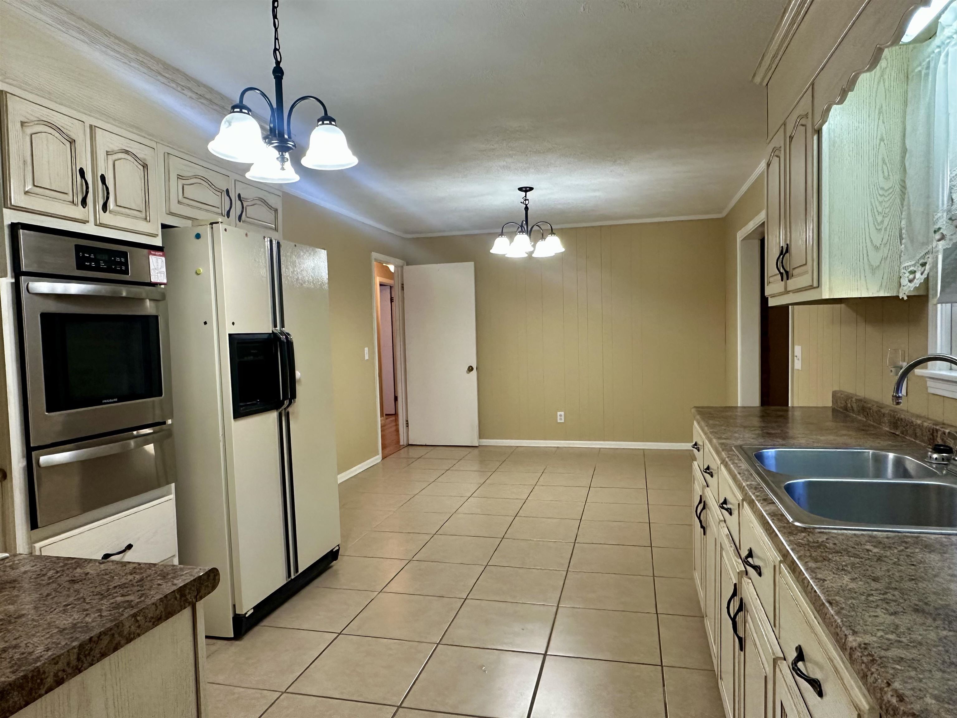 136 Perkins Street Selmer, TN 38375 - Photo 9 of 25 a kitchen with stainless steel appliances granite countertop a sink a stove and a refrigerator