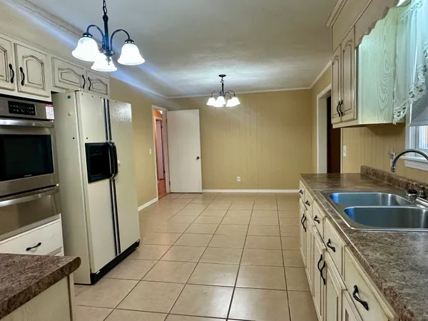 a kitchen with a sink cabinets and stainless steel appliances