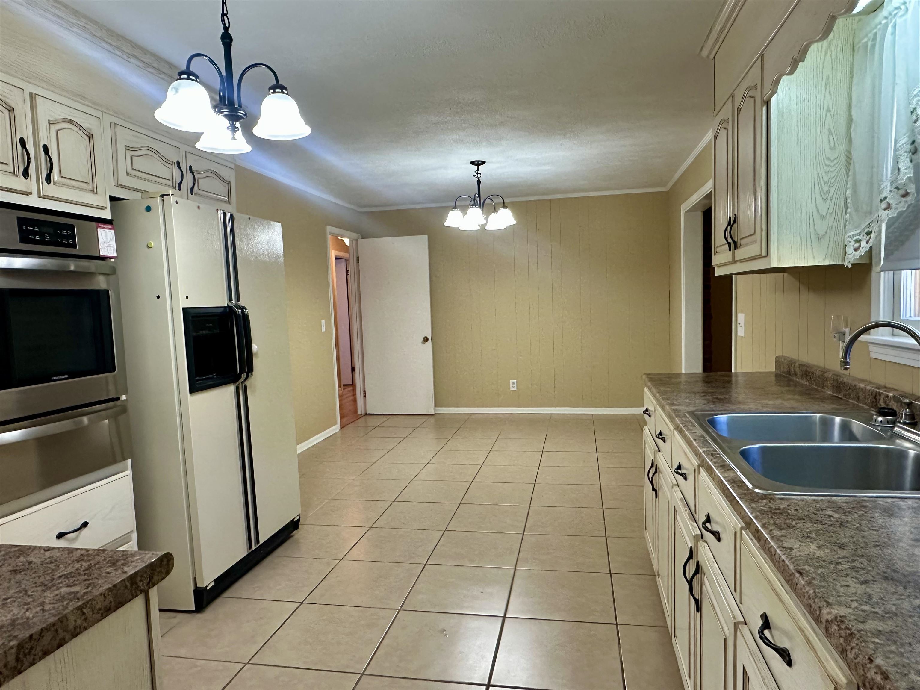 136 Perkins Street Selmer, TN 38375 - Photo 10 of 25 a kitchen with a sink cabinets and stainless steel appliances