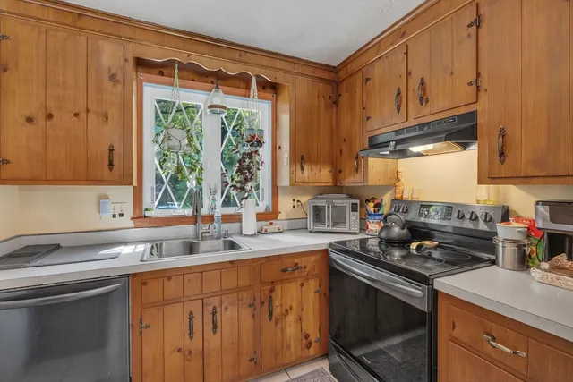 a kitchen with stainless steel appliances granite countertop a sink stove and cabinets