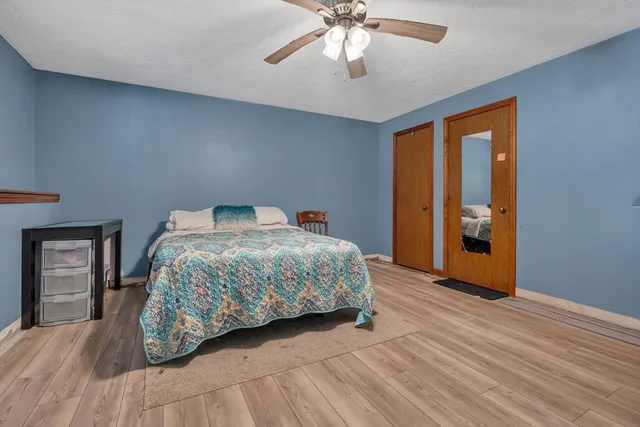 a bedroom with a large bed and a chandelier