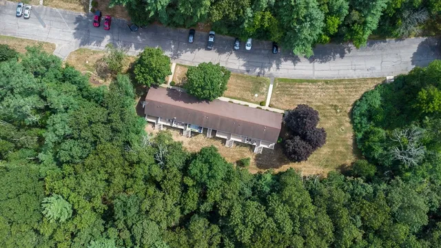 an aerial view of a house with a yard