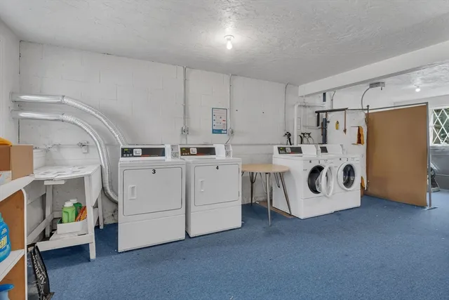 a utility room with cabinets washer and dryer