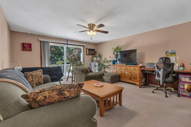 a living room with furniture flat screen tv and a window
