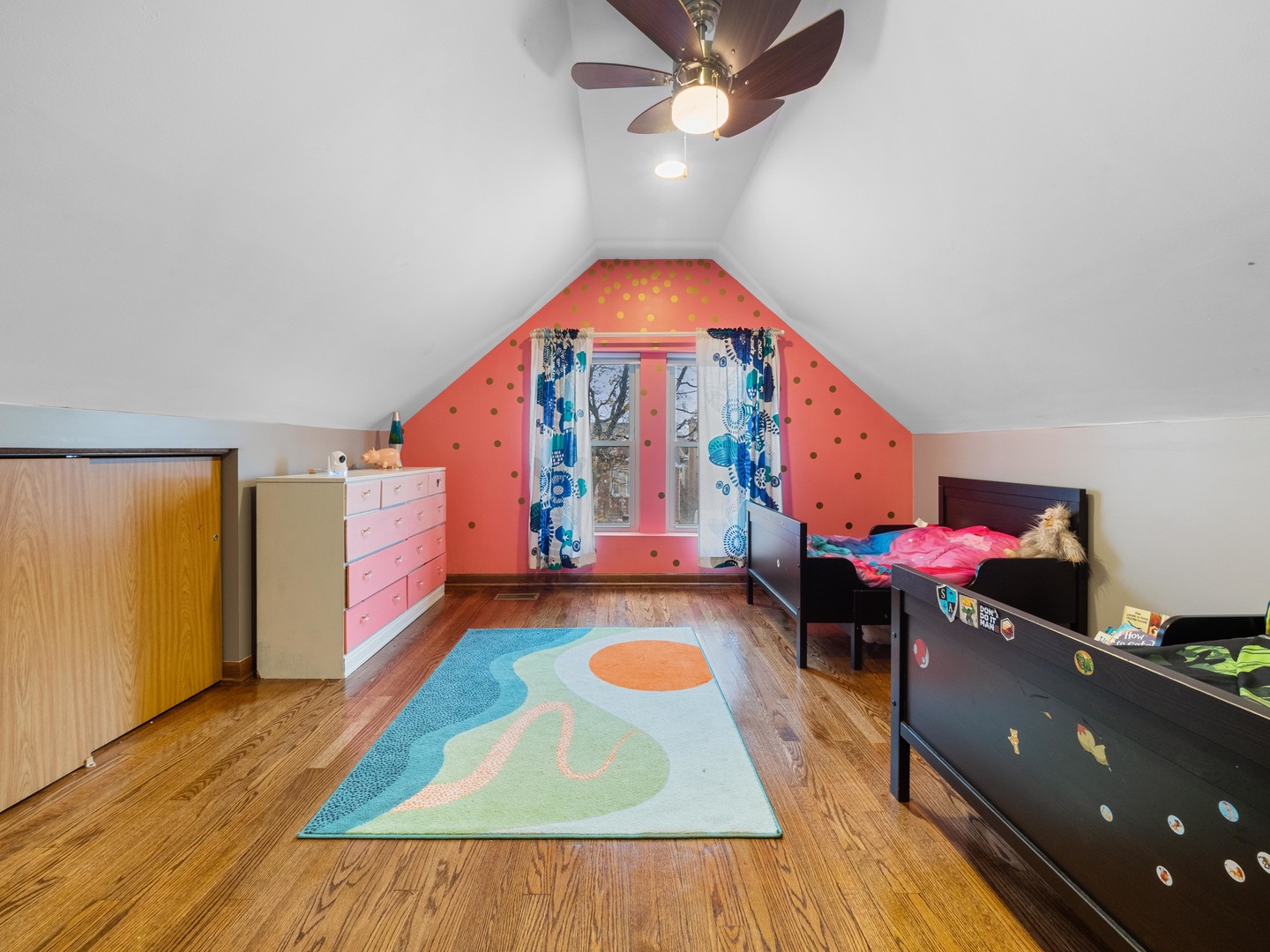 3306 North Nottingham Avenue Chicago, IL 60634 - Photo 15 of 25 a living room with a gaming machine and a dining table with wooden floor