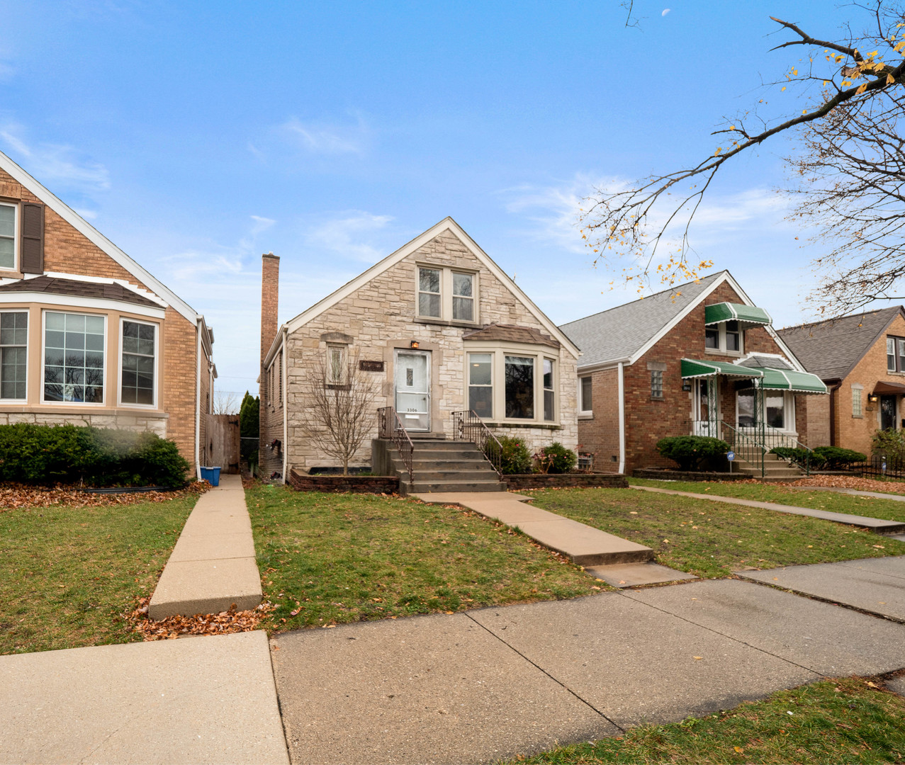 3306 North Nottingham Avenue Chicago, IL 60634 - Photo 3 of 25 a front view of a house with a yard
