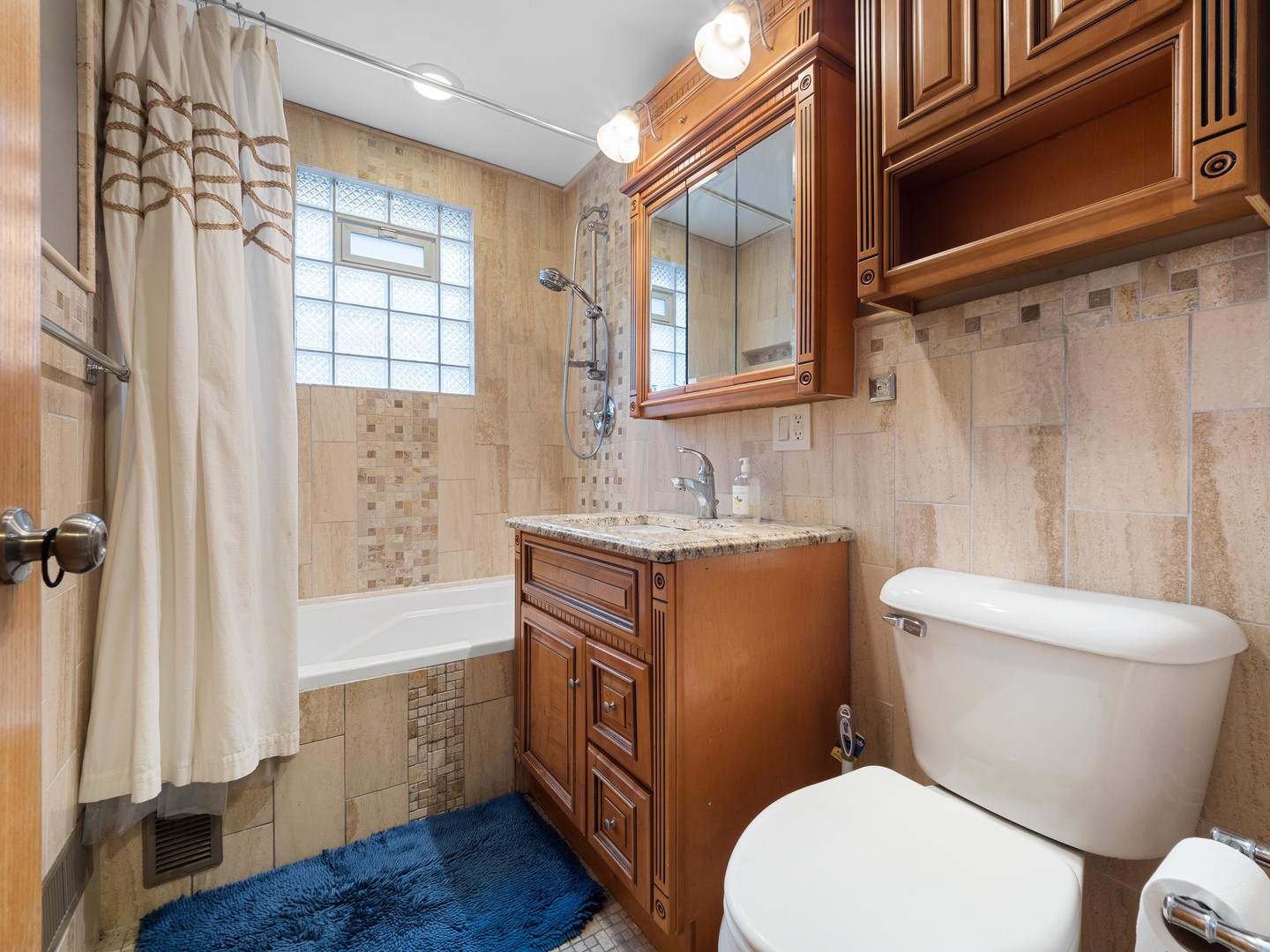 3306 North Nottingham Avenue Chicago, IL 60634 - Photo 7 of 25 a bathroom with a granite countertop toilet sink and mirror