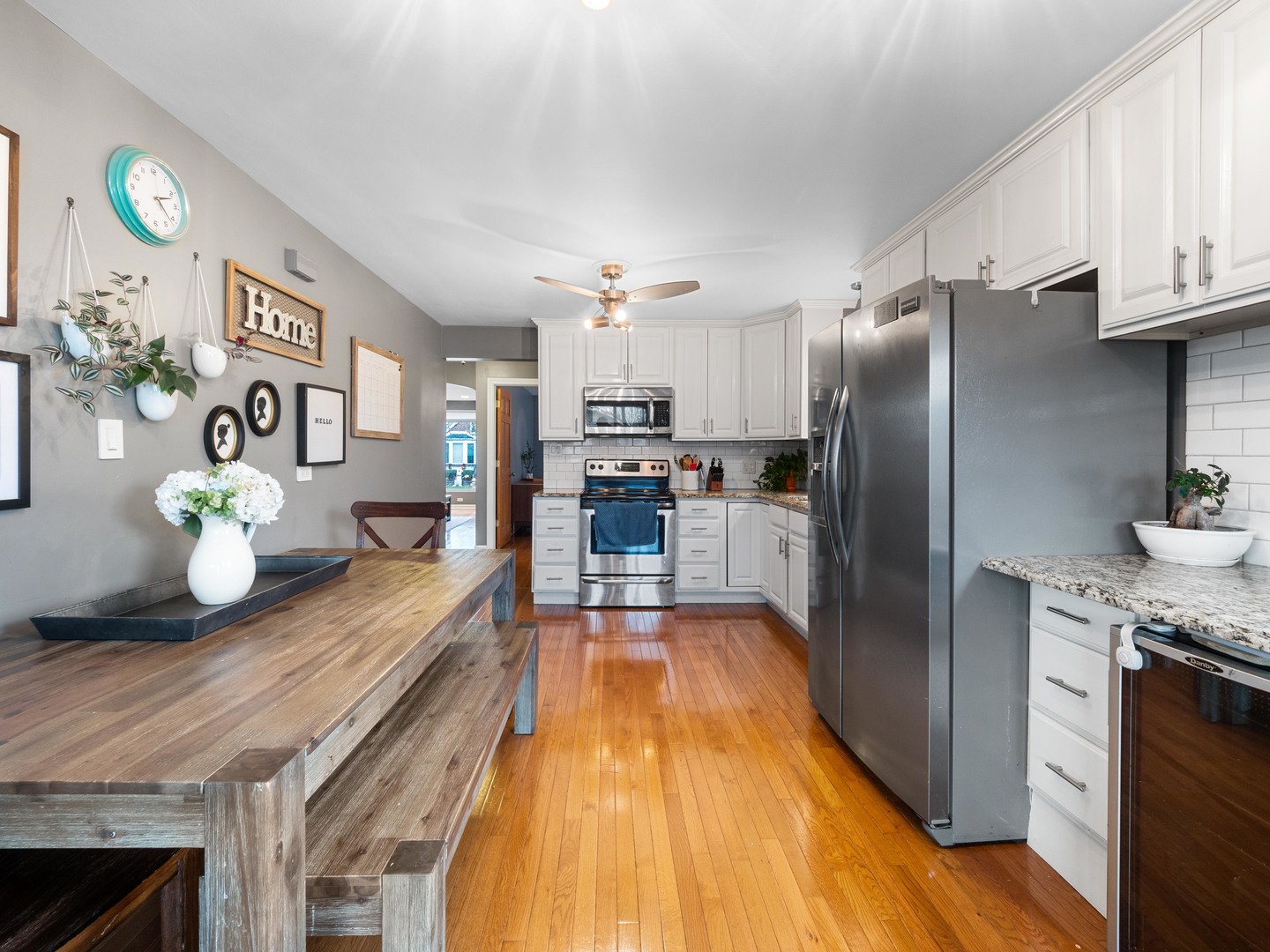 3306 North Nottingham Avenue Chicago, IL 60634 - Photo 10 of 25 a kitchen with granite countertop a refrigerator a stove and a wooden floor