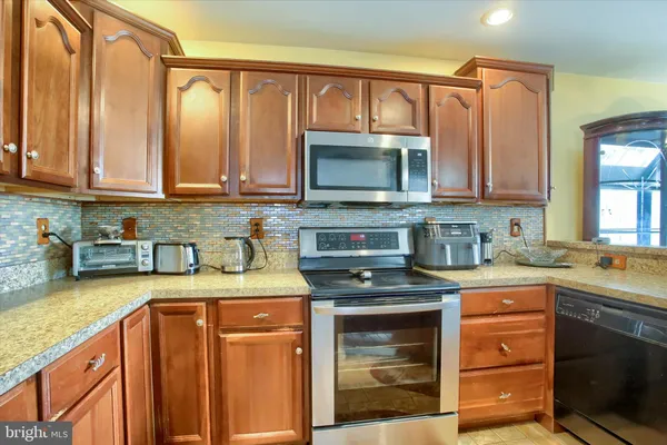a kitchen with a stove a sink and a microwave