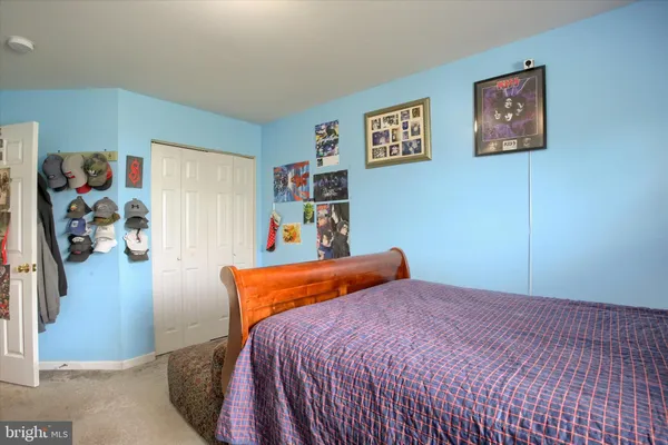 a bedroom with a bed and a couch