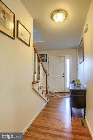 a view of entryway and hall with wooden floor