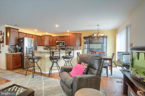 a living room with lots of furniture and kitchen view