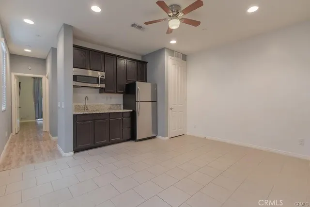 a kitchen with stainless steel appliances a refrigerator and a sink