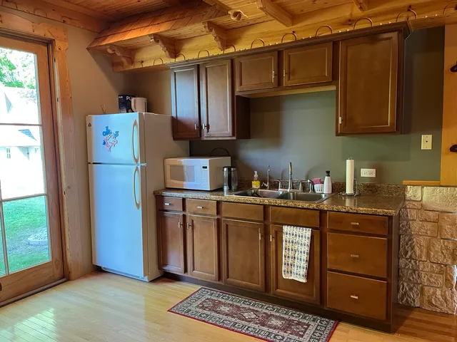 a kitchen with stainless steel appliances granite countertop a refrigerator and a sink