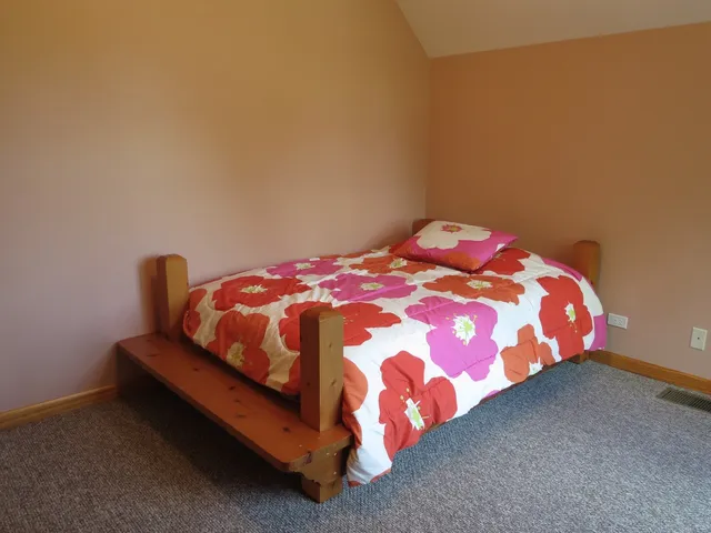 a bedroom with a bed and window