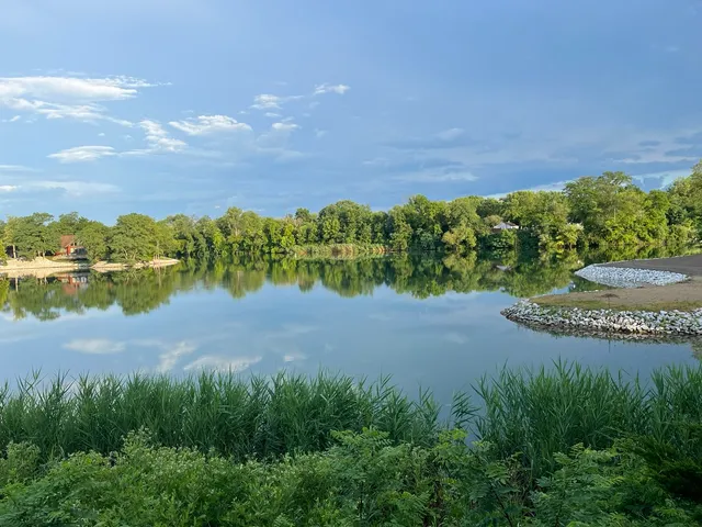 a view of a lake with houses in the back