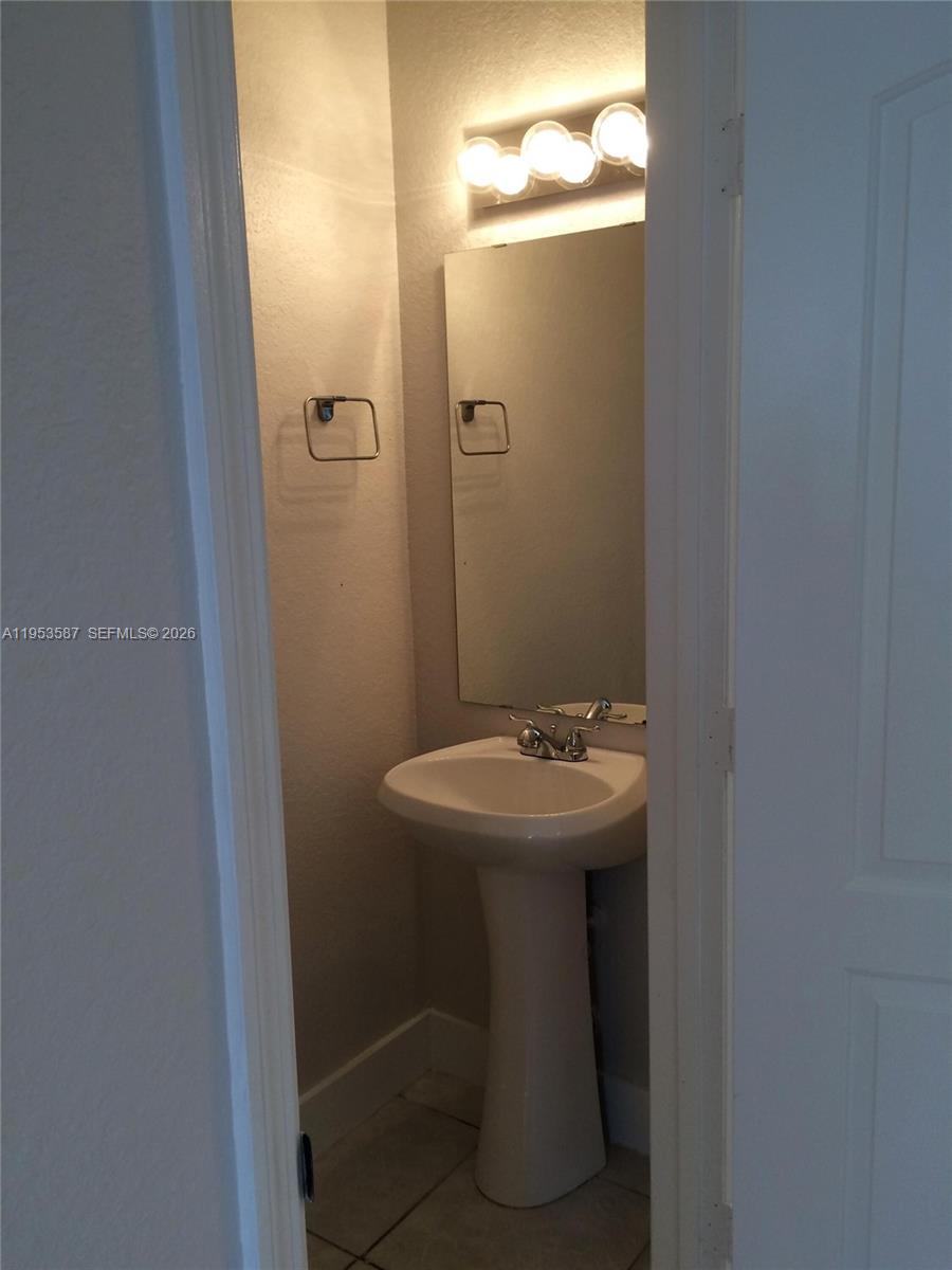 2201 Monroe Street, Unit B2 Hollywood, FL 33020 - Photo 4 of 12 a bathroom with a sink and mirror