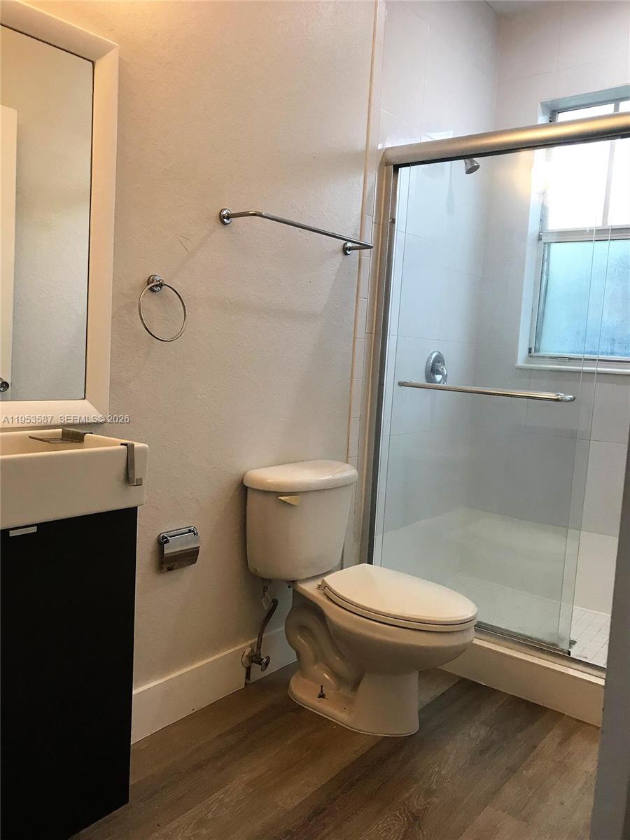 2201 Monroe Street, Unit B2 Hollywood, FL 33020 - Photo 6 of 12 a white toilet sitting next to a bathroom sink