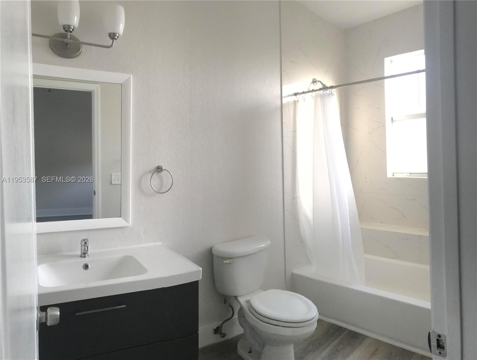 2201 Monroe Street, Unit B2 Hollywood, FL 33020 - Photo 8 of 12 a bathroom with a sink a toilet a mirror and shower