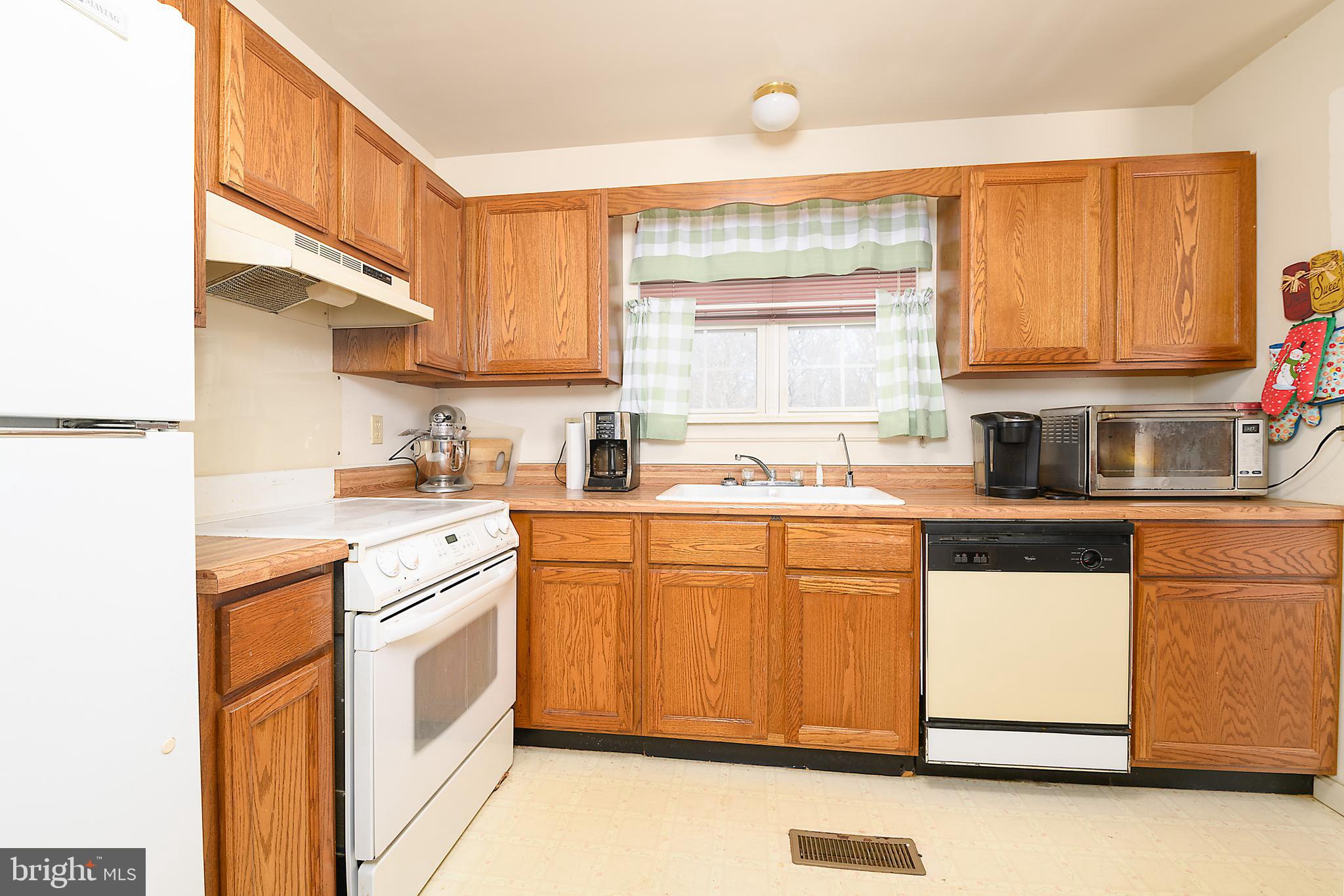 1024 Fence Post Lane Viola, DE 19979 - Photo 16 of 47 a kitchen with stainless steel appliances white cabinets and a sink