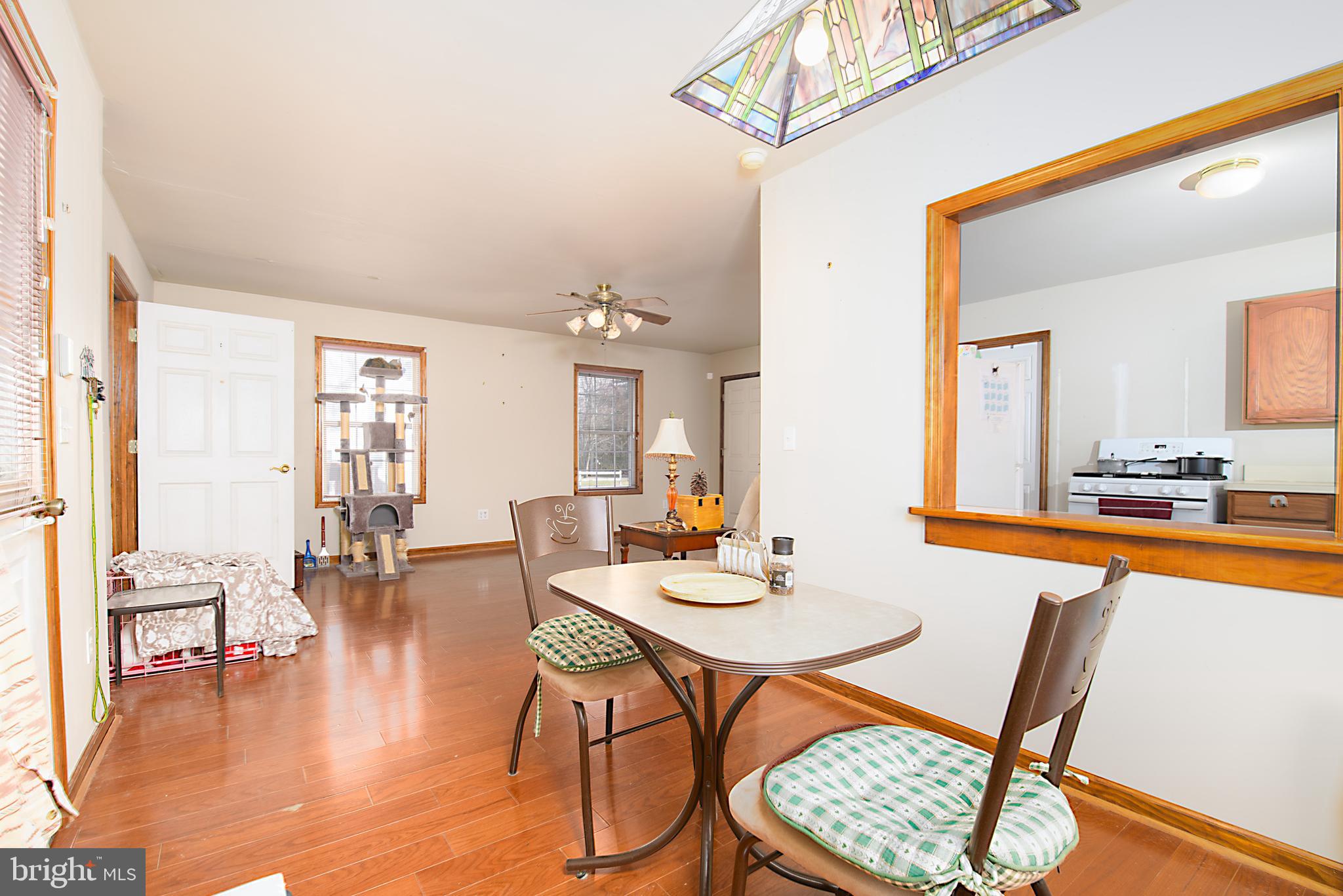 1024 Fence Post Lane Viola, DE 19979 - Photo 27 of 47 a dining room with wooden floor and a chandelier