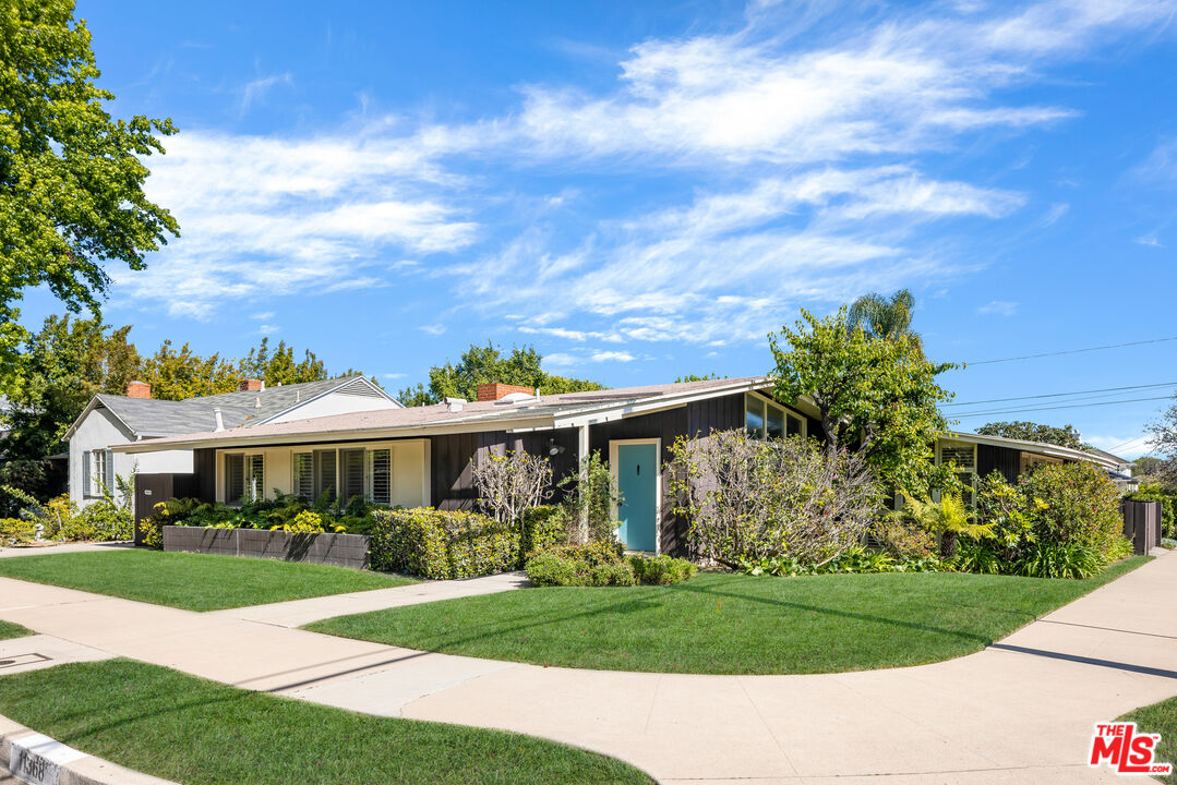 11368 Berwick Street Los Angeles, CA 90049 - Photo 1 of 31 a front view of a house with a yard