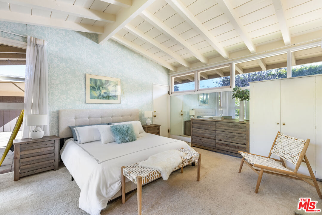 11368 Berwick Street Los Angeles, CA 90049 - Photo 13 of 31 a bedroom with a bed a chair and painting on the wall