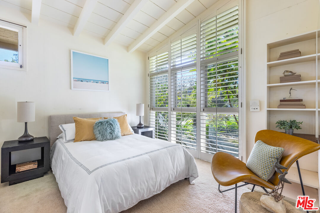 11368 Berwick Street Los Angeles, CA 90049 - Photo 16 of 31 a bedroom with a bed a chair and next to a window