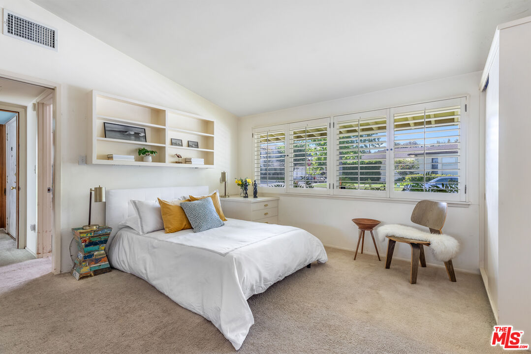 11368 Berwick Street Los Angeles, CA 90049 - Photo 17 of 31 a bedroom with a bed and a large window