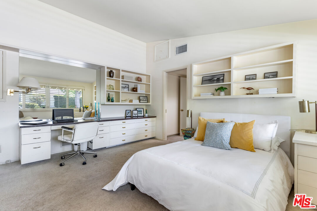 11368 Berwick Street Los Angeles, CA 90049 - Photo 18 of 31 a bedroom with a large bed and a cabinets