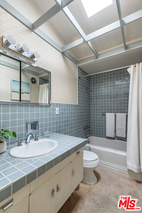 11368 Berwick Street Los Angeles, CA 90049 - Photo 19 of 31 a bathroom with a sink a toilet and shower