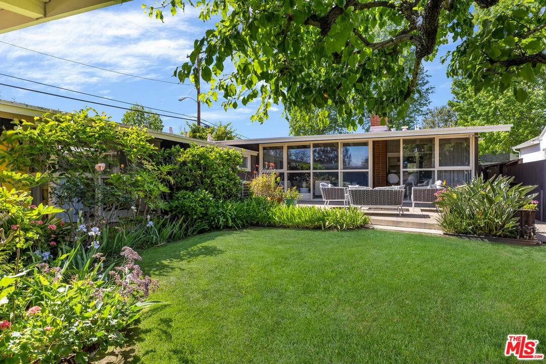 11368 Berwick Street Los Angeles, CA 90049 - Photo 22 of 31 a view of a house with backyard sitting area and garden