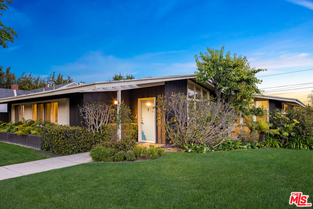 11368 Berwick Street Los Angeles, CA 90049 - Photo 24 of 31 a view of a house with a yard