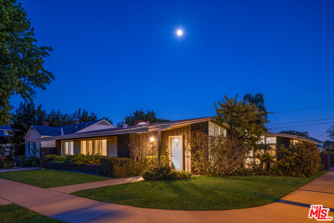11368 Berwick Street Los Angeles, CA 90049 - Photo 29 of 31 a view of a big house with a big yard and palm trees