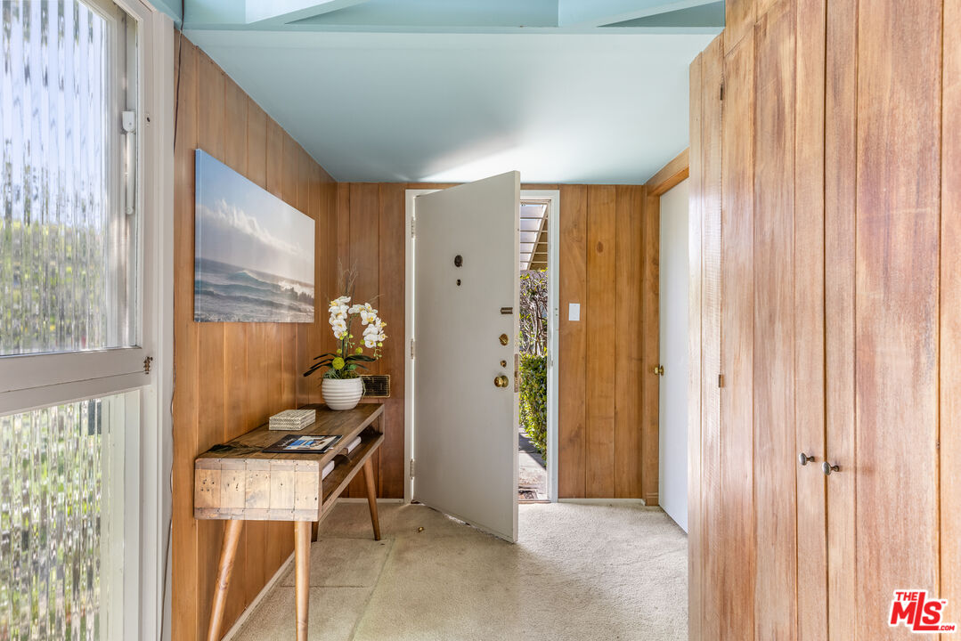 11368 Berwick Street Los Angeles, CA 90049 - Photo 4 of 31 a view of a hallway with furniture and a window