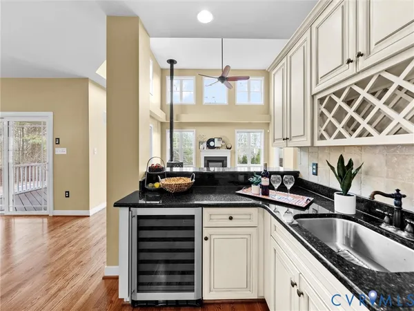 a spacious bedroom with a bed a chandelier and glass door