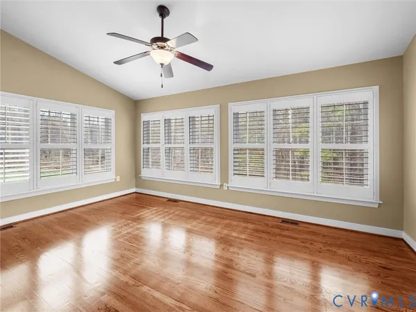 a view of a livingroom with a ceiling fan and window
