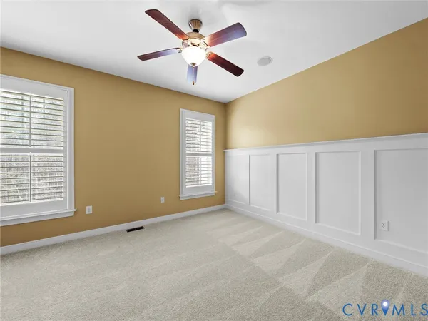 a view of a house with a yard and pathway