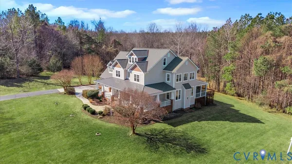 a view of an empty room with wooden floor fireplace and a window