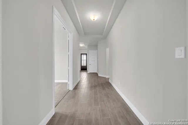 a view of a hallway with wooden floor
