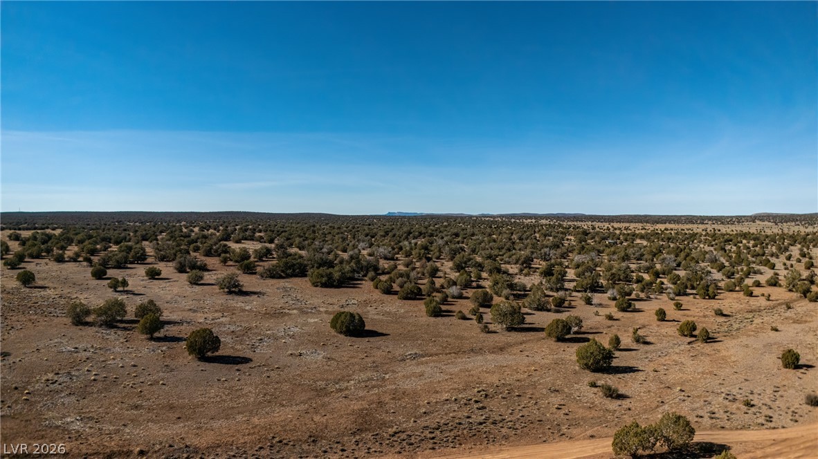 0 X-One Ranch Road Seligman, AZ 86337 - Photo 3 of 9 A vast, open expanse of undeveloped land offers endless possibilities under a clear sky.