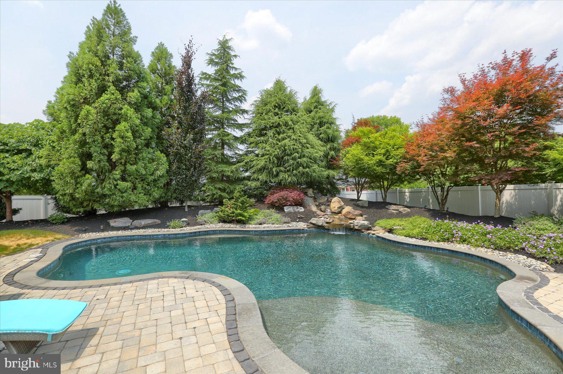 an outdoor space with swimming pool and furniture